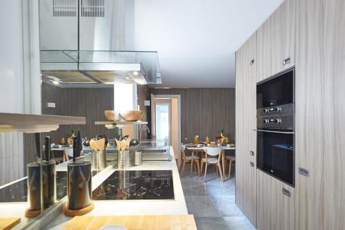 a kitchen with a table and a dining room at Oxford Park II in Cascais