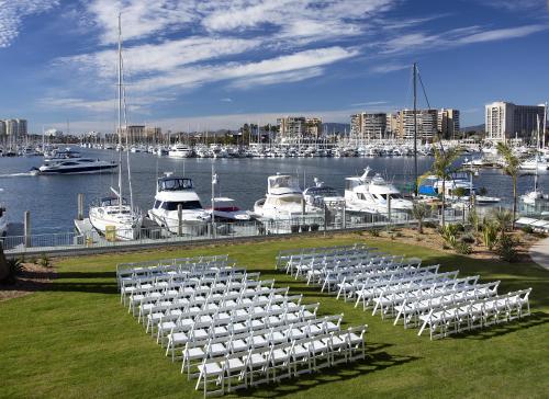 a rows of white chairs in a marina with boats at Marina del Rey Hotel in Los Angeles