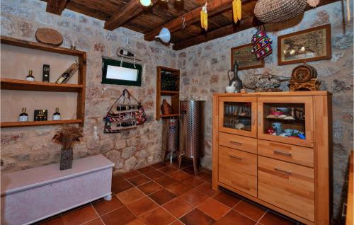 a bathroom with a wooden cabinet and a tv at Gorgeous Home In Slivno With Heated Swimming Pool in Slivno