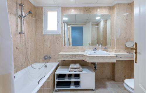 a bathroom with a tub and a sink and a bath tub at 2 Bedroom Gorgeous Apartment In Marbella-elviria in Marbella