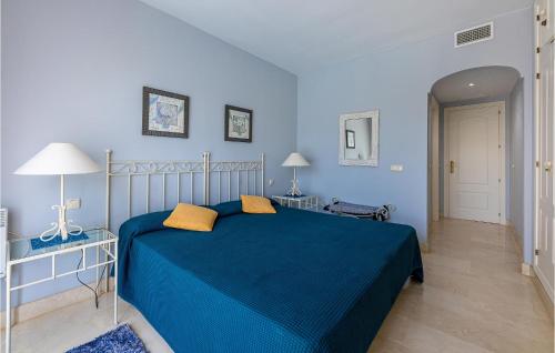 a blue bedroom with a blue bed and two lamps at 2 Bedroom Gorgeous Apartment In Marbella-elviria in Marbella