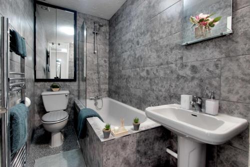 uma casa de banho com um lavatório, um WC e uma banheira em Welshside - Modern One Bedroom House, Welsh Harp, NW London By MDPS em Edgware