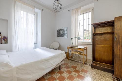 sypialnia z łóżkiem, biurkiem i oknami w obiekcie HospitalityRome Comfortable Apartament with Terrace w Rzymie