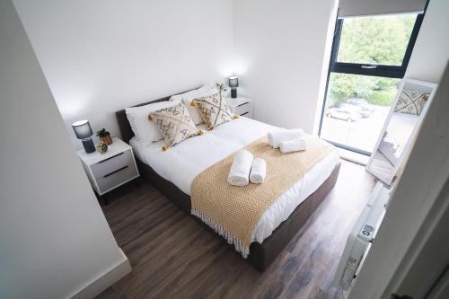 a bedroom with a bed with two towels on it at The Interchange - 2-Beds - Brand New - Central in Manchester