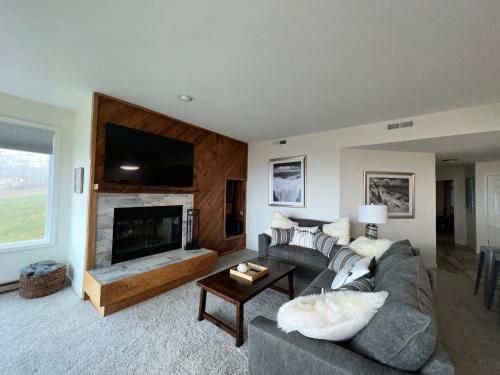 a living room with a couch and a fireplace at Diamond Adventure Slope Side with Foosball and Arcade at Wintergreen Resort in Wintergreen