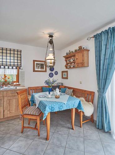 a dining room with a table and two chairs at Zum Sonnenhuegel in Wegscheid