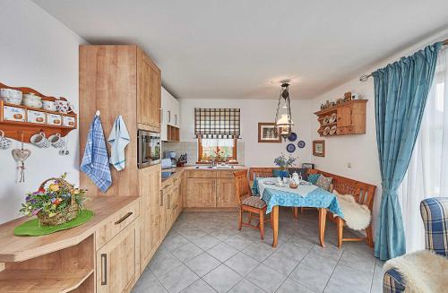 a kitchen with a table and a dining room at Zum Sonnenhuegel in Wegscheid