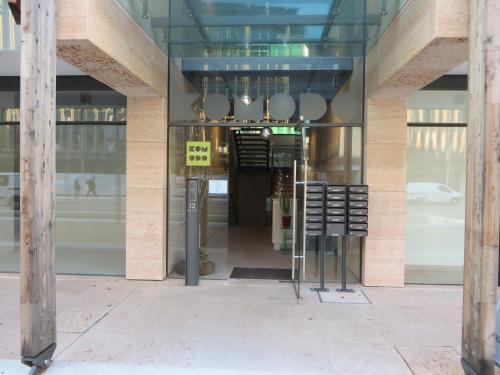 an entrance to a building with a sale sign in the window at Komodo short stay apartments in Trento