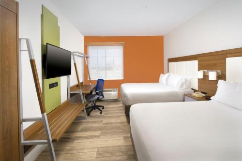a hotel room with two beds and a flat screen tv at Holiday Inn Express & Suites San Antonio - Downtown Market Area by IHG in San Antonio