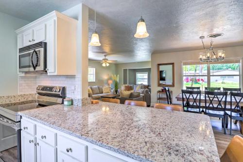 a kitchen with a counter top and a living room at Merritt Island Oasis with Pool about 7 Mi to Beach! in Merritt Island