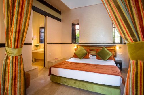 a bedroom with a bed in a room with curtains at Hapimag Resort Marrakesh in Douar Soukkane