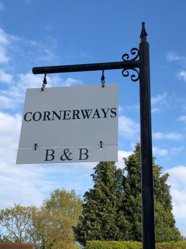 a sign on a pole that readsromyews baby at Cornerways B&B in Chipping Campden