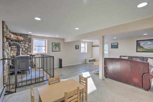 a living room with a table and a stone wall at Family-Friendly Woodbury Home with Yard and Deck! in Woodbury