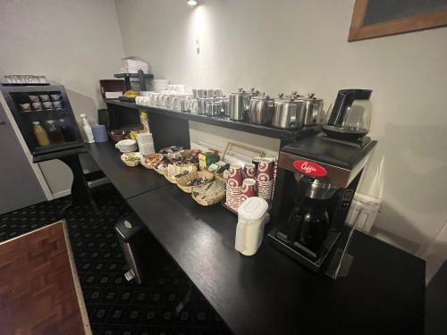 a kitchen with a counter with food and a coffee maker at Smithton Hotel in Inverness