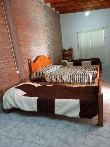 two beds sitting next to each other in a room at Depto Guemes in San Luis