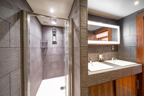 a bathroom with two sinks and a shower at The Shore Apartment in Queensferry