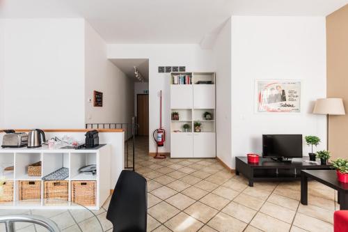 a living room with a table and a tv at Portobello Apartments in Bologna