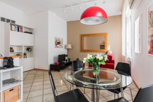 a living room with a glass table and chairs at Portobello Apartments in Bologna