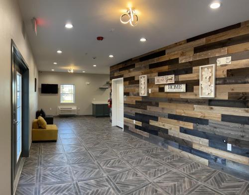 a lobby with a wall made out of wood at The Residency Suites in Sugar Land