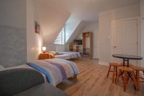 a bedroom with two beds and a table in a room at HELENOWO in Lutowiska