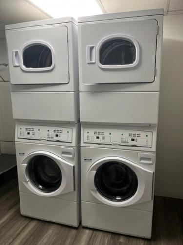 four washers and dryers stacked on top of each other at Baymont by Wyndham Fort McMurray in Fort McMurray