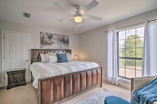 a bedroom with a bed with a ceiling fan and a window at Starkvegas Clubhouse about 2 Mi to MSU Campus! in Starkville