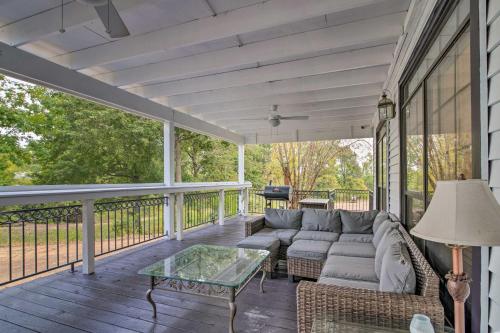 a screened in porch with a couch and a glass table at Starkvegas Clubhouse about 2 Mi to MSU Campus! in Starkville