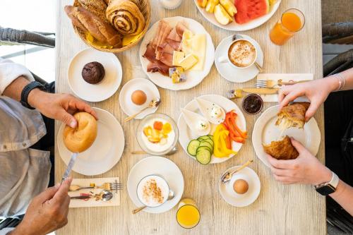 a table filled with plates of breakfast food at Wellness Landhaus Parth in Ossiach