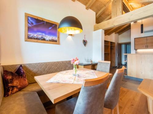 a dining room with a wooden table and chairs at Apartments Heissangerer in Tulfes