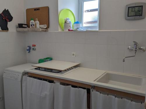 a kitchen with a sink and a counter top at Maison familiale avec grand jardin près du Périgord - 3 chambres, WIFI et vélos fournis - FR-1-653-171 in Combiers