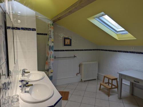 a bathroom with two sinks and a shower and a window at Maison familiale avec grand jardin près du Périgord - 3 chambres, WIFI et vélos fournis - FR-1-653-171 in Combiers