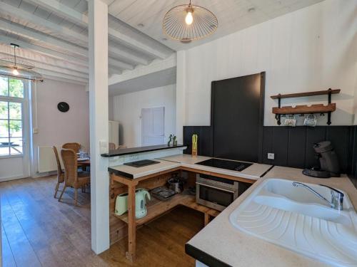 une cuisine avec un évier et un plan de travail dans l'établissement Gîte familial avec piscine chauffée, jardin privé et équipements bébé en Charente - FR-1-653-182, à Montmoreau