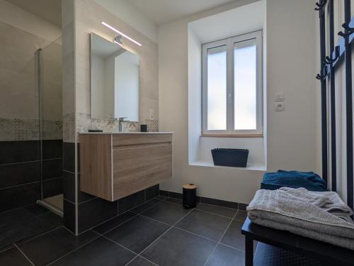 a bathroom with a sink and a mirror at Maison en pierres rénovée avec jardin, terrasse, 3 chambres, proche village, nature paisible, équipements complets - FR-1-653-187 in Montboyer