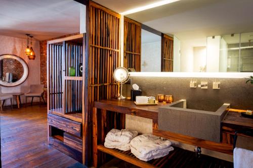 a bathroom with a sink and a mirror at Múbú Hotel Boutique in Valle de Bravo