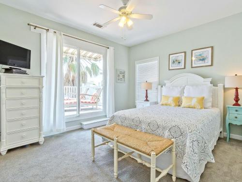 a bedroom with a white bed and a window at Driftaway in Tybee Island