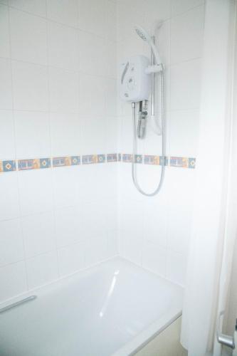 a white bathroom with a shower and a tub at Lovely 1 bedroom Apartment in Central High Wycombe in Buckinghamshire