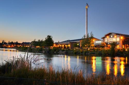 a building next to a river at night at Holiday Inn Express & Suites - Bend South by IHG in Bend