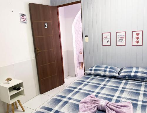 a bedroom with a bed with blue and white sheets at Residencial Napolitan in Manaus