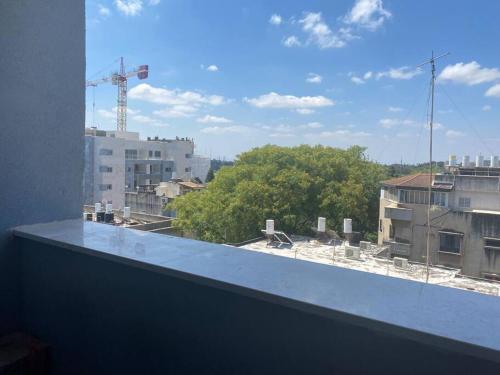 a view of a city skyline from a window at Stunning four bedroom duplex in central Raanana in Ra‘ananna