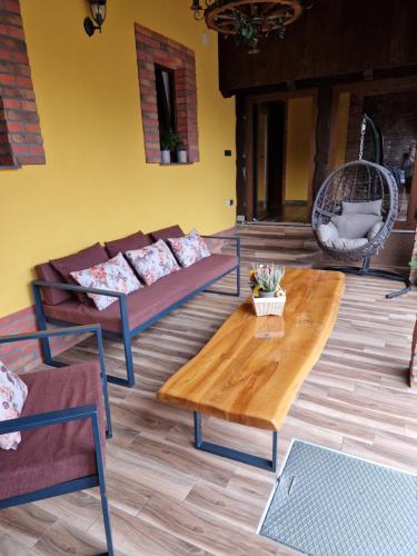 a living room with couches and a coffee table at Relax&Wine house Klara in Ruškovac