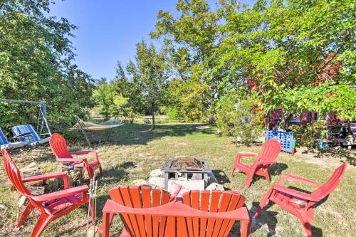 a group of chairs and a fire pit in a yard at Steps to Lake! Charming Cabin Pool Access and Decks in Granbury