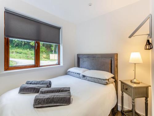 a bedroom with a white bed with a window at Waterside Lodge Six - Uk38264 in Southowram