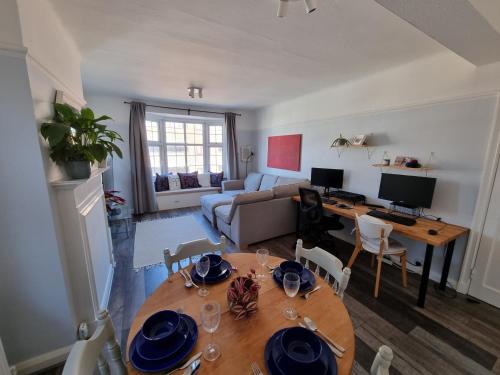 a living room with a wooden table and a dining room at Lovely 2 bedroom flat in North West London in Hendon