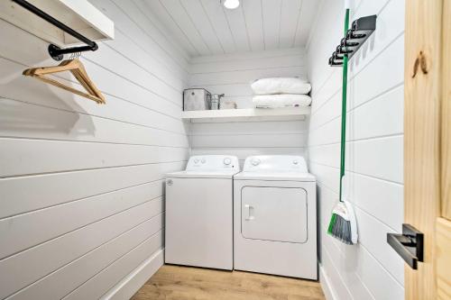 a white laundry room with a washer and dryer at A Little Bit of Simple Cabin with Pond Access in Broken Bow