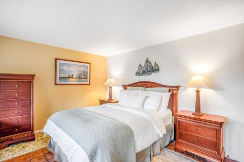 a bedroom with a large bed and two nightstands and two lamps at Hidden Luxury Beachfront Estate in Yachats