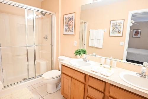 ein Bad mit einer Dusche, einem WC und einem Waschbecken in der Unterkunft Disney Home + Private Pool in Davenport