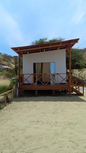 a small building with a roof on a beach at Hospedaje "Las Brisas de Zorritos" in Zorritos