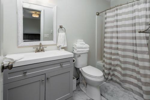 a bathroom with a sink and a toilet and a shower at Charming Family Home 7 mins to Beach Dog Friendly in Ocean City