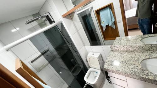 a bathroom with two sinks and a toilet at The Expression 112 in Goiânia