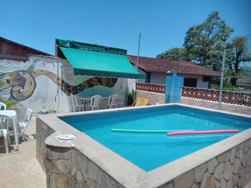 a swimming pool in a stone retaining wall with a swimming pool at Leo's Clan Beach Hostel in Paraty